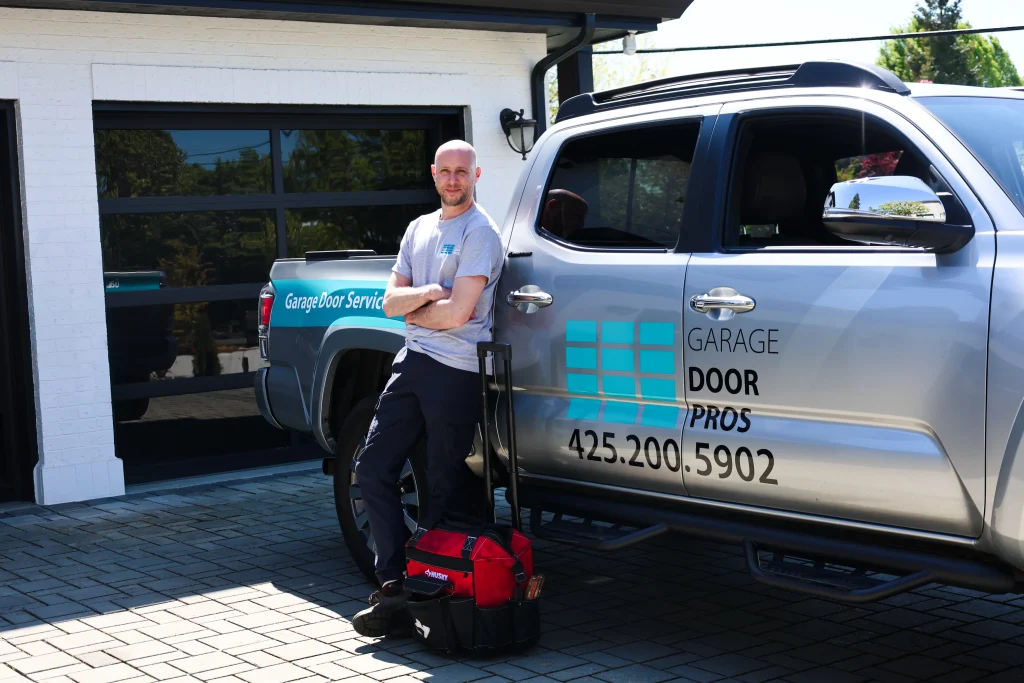 fully equipped company service truck and a rolling tool bag on a paved driveway, showcasing a premium Garage Door Installation Service in Kirkland, WA.