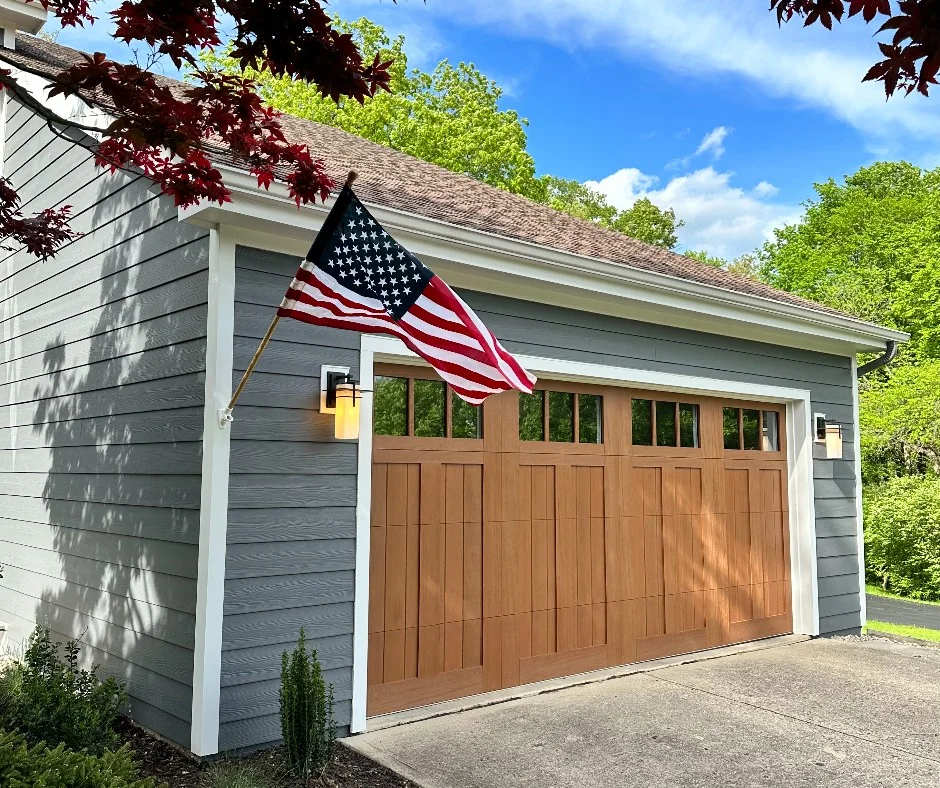 window panes is installed on a modern home with gray lap siding, showcasing a premium replacement option as seen in Signs You Need a New Garage Door