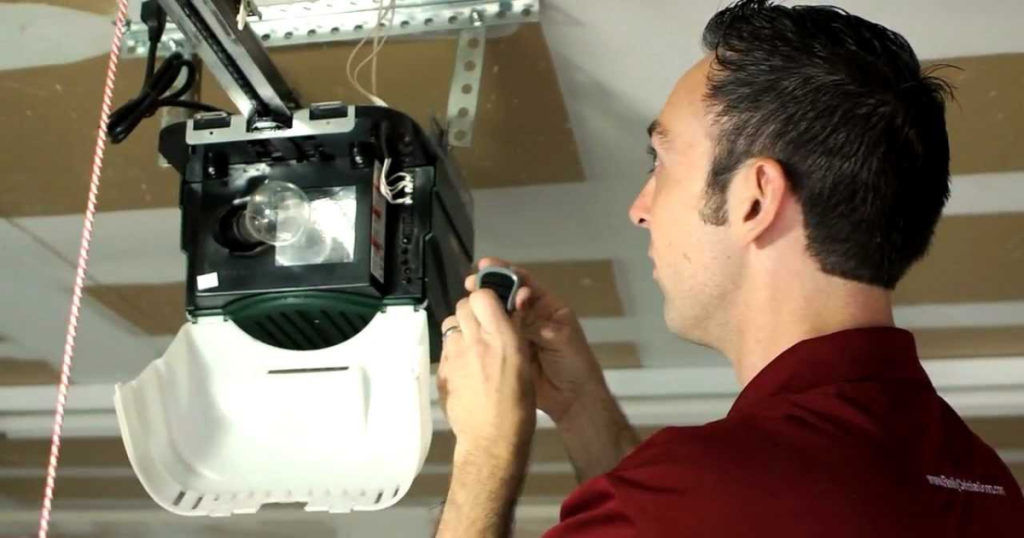 Man programs remote to garage door opener.